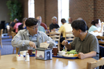Two International Students Eating in the Dining Hall by Asbury Theological Seminary Communications
