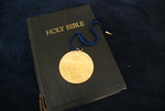 The Presidential Medal on Top of a Closed Bible by Asbury Theological Seminary Communications