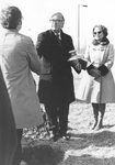 Man holding urn containing ESJ's ashes at at burial service at Bishops Lot, Baltimore, MD, 1973